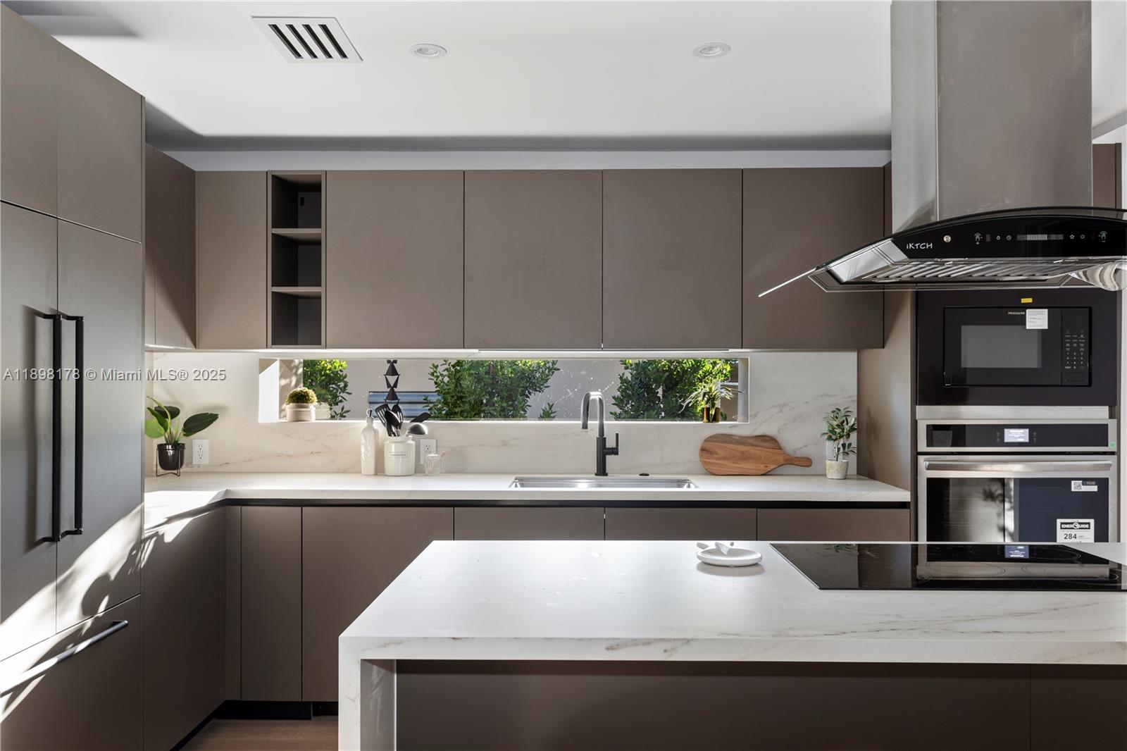 2434 Southwest 19th Street Miami, FL 33145 - Photo 6 of 18 a kitchen with a stove and a microwave