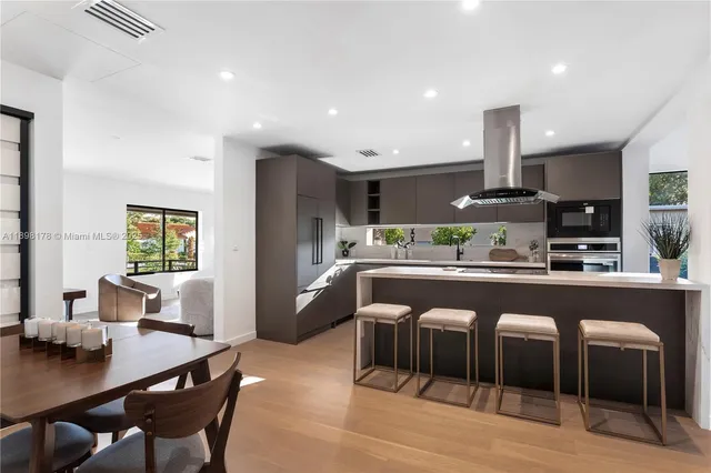 a large kitchen with a table and chairs