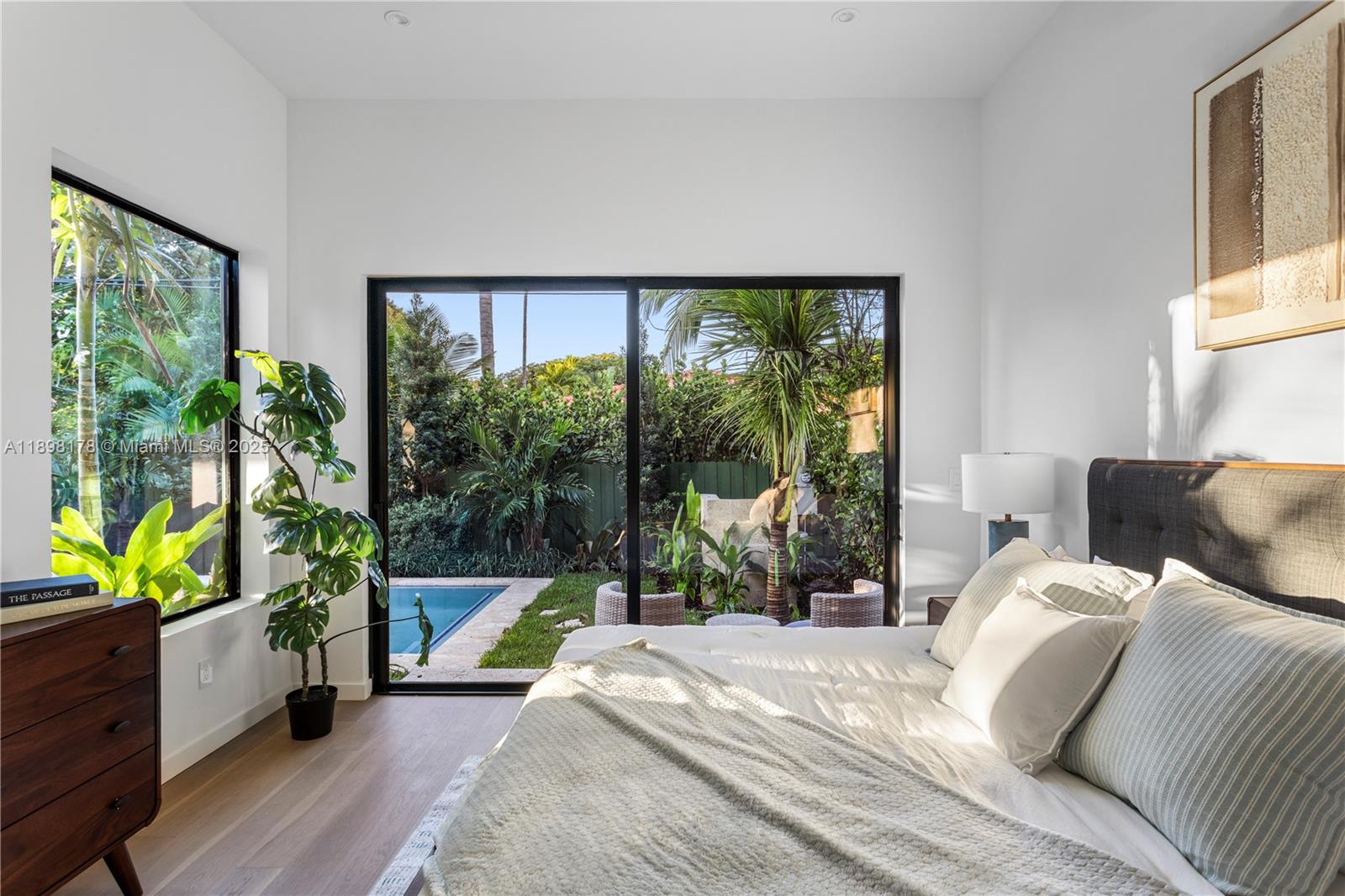 2434 Southwest 19th Street Miami, FL 33145 - Photo 10 of 18 a bedroom with a bed and a large window with outer view