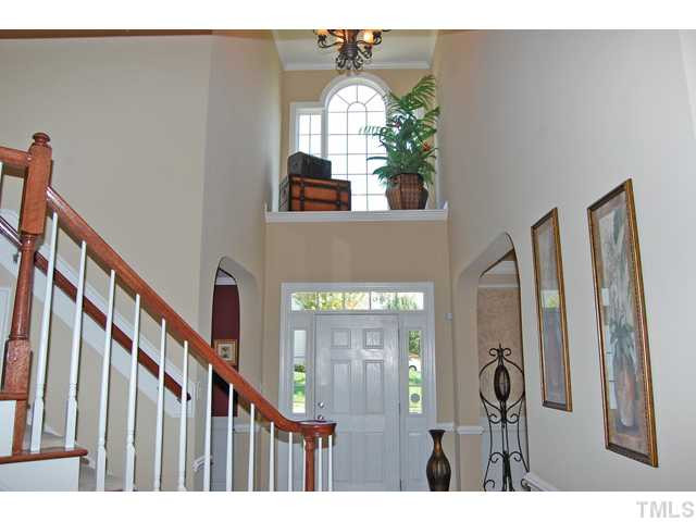 9219 Stone Mountain Road Raleigh, NC 27613 - Photo 3 of 25 The two-story foyer greets you with crown, a chandelier, catwalk, planter shelf, and warm hardwood floors that carry through-out most of the main level. Foyer