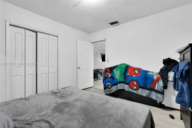 a bed sitting in a bedroom next to a bathroom