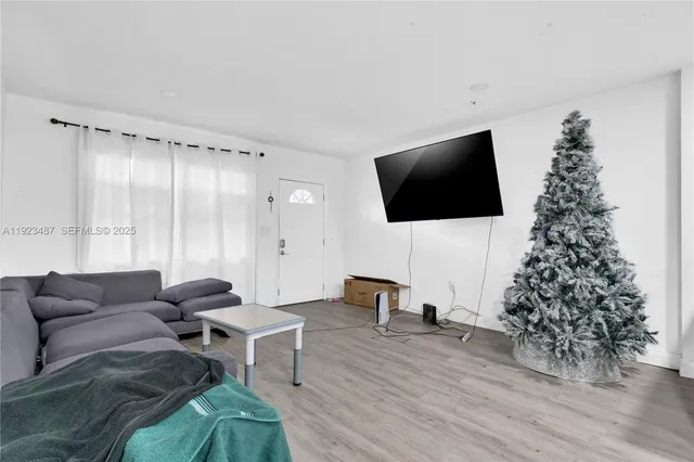 a living room with furniture and kitchen view