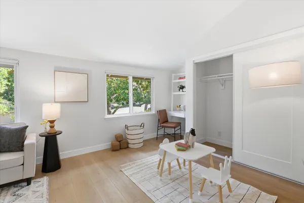 a bedroom with a bed and painting on the wall