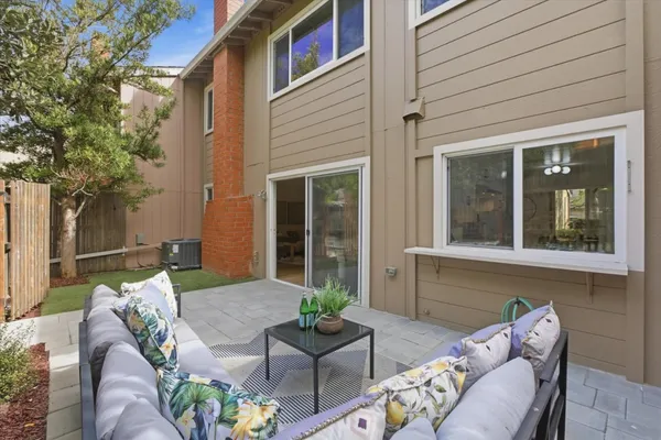 a backyard of a house with outdoor seating