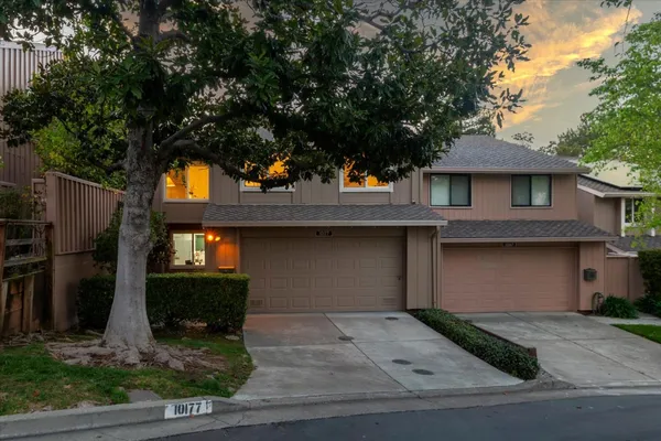 a view of a house with trees in the background