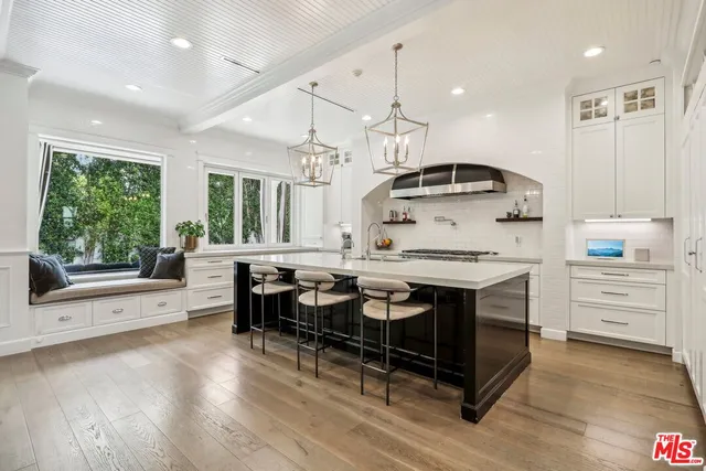 a kitchen with stainless steel appliances granite countertop a stove and a wooden floors