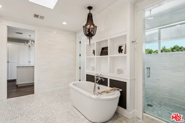 a bathroom with a bathtub and shower