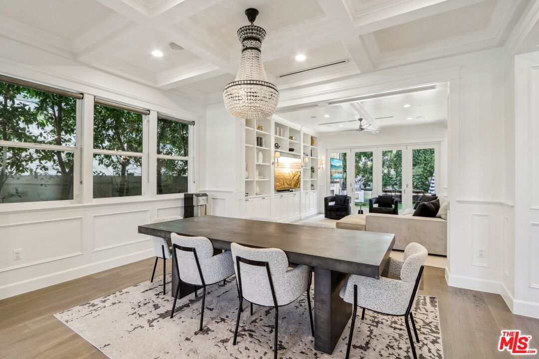 14000 Morrison Street Sherman Oaks, CA 91423 - Photo 7 of 34 a dining room with wooden floor a chandelier a wooden table and chairs