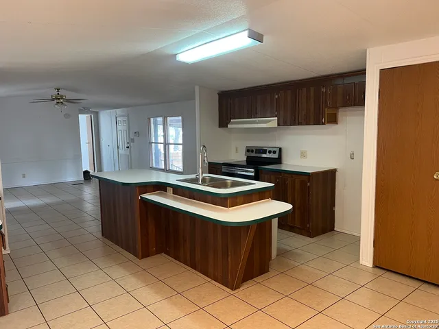 a kitchen with stainless steel appliances granite countertop a stove a sink dishwasher and a refrigerator