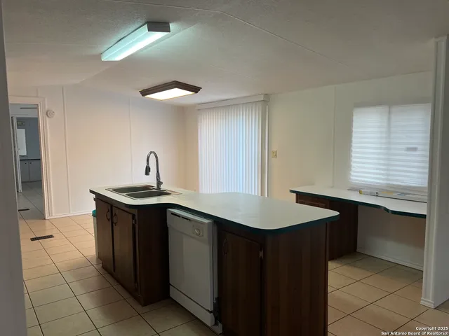 a kitchen with stainless steel appliances granite countertop a sink and a stove