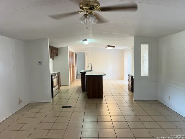 a view of a kitchen with a sink and cabinets