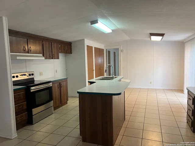 a kitchen with stainless steel appliances a sink and a stove