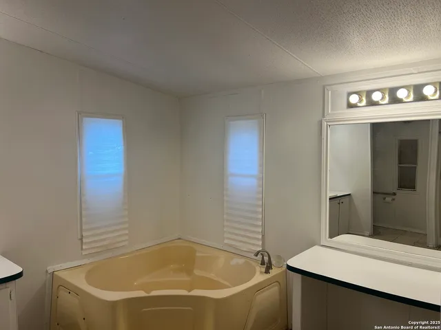a bathroom with a tub and a sink
