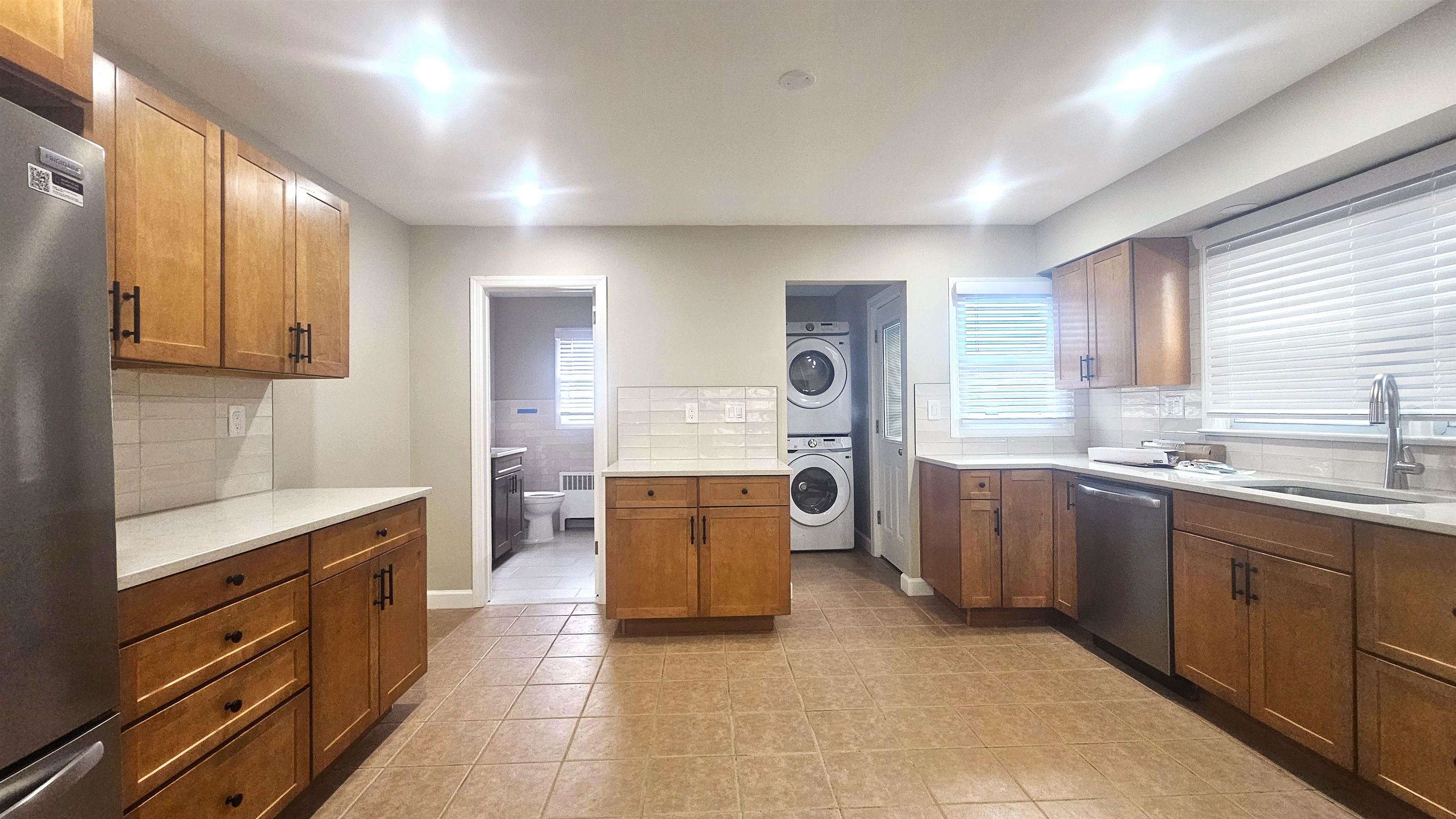 a kitchen with a sink stove and wooden cabinets