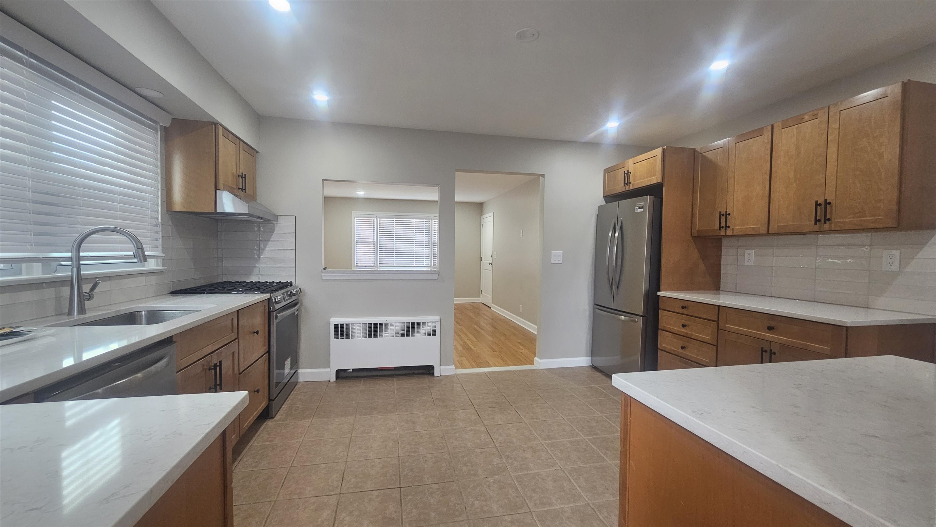 736 3rd Street, Unit 1 Secaucus, NJ 07094 - Photo 12 of 15 a kitchen with stainless steel appliances granite countertop a sink stove and refrigerator