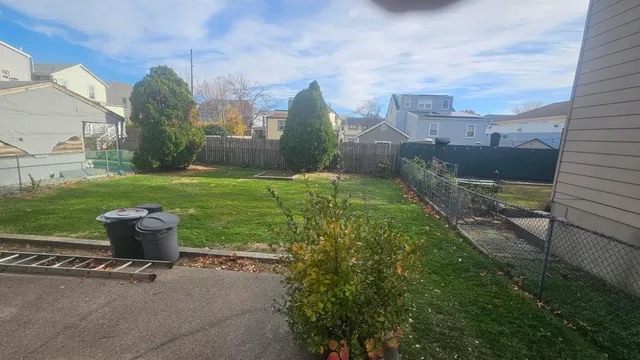 a view of a garden with a bench in front of it