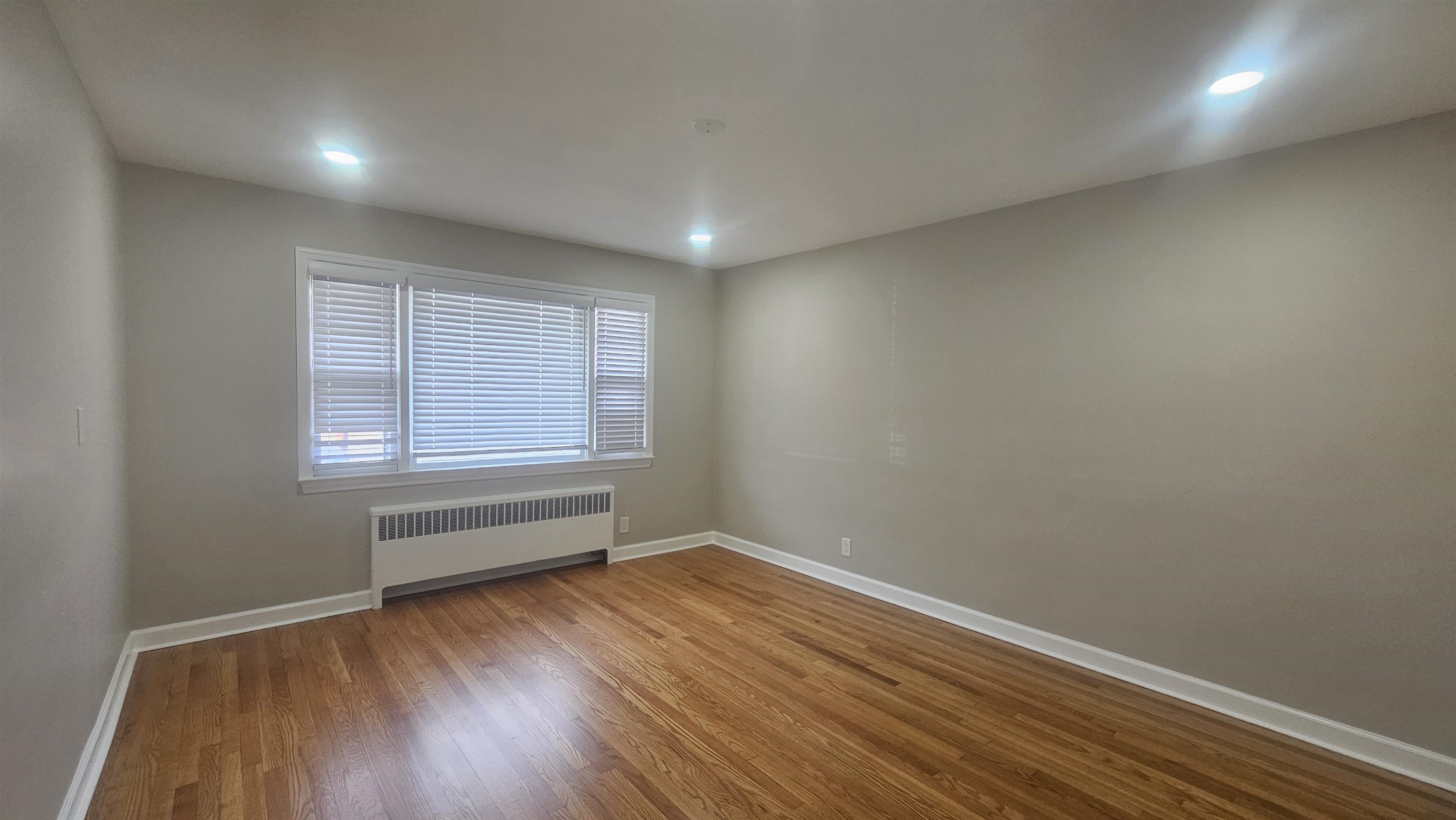 736 3rd Street, Unit 1 Secaucus, NJ 07094 - Photo 3 of 15 wooden floor in an empty room with a window