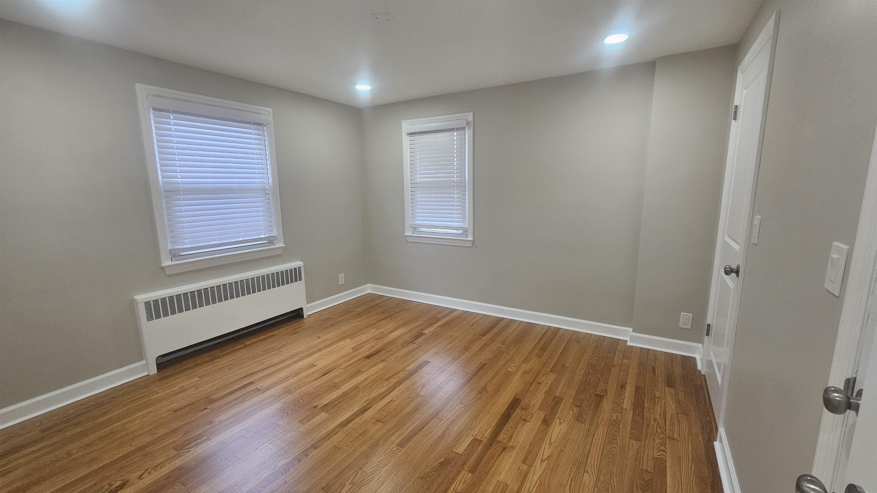 736 3rd Street, Unit 1 Secaucus, NJ 07094 - Photo 5 of 15 an empty room with wooden floor and windows