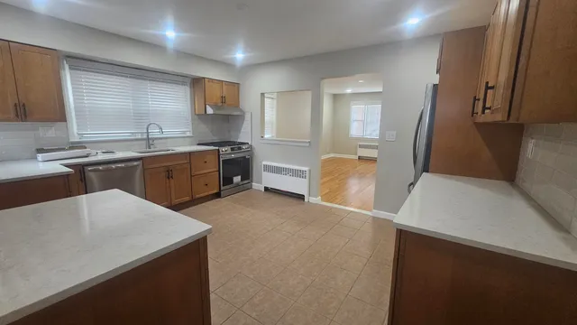 a large kitchen with cabinets and wooden floor