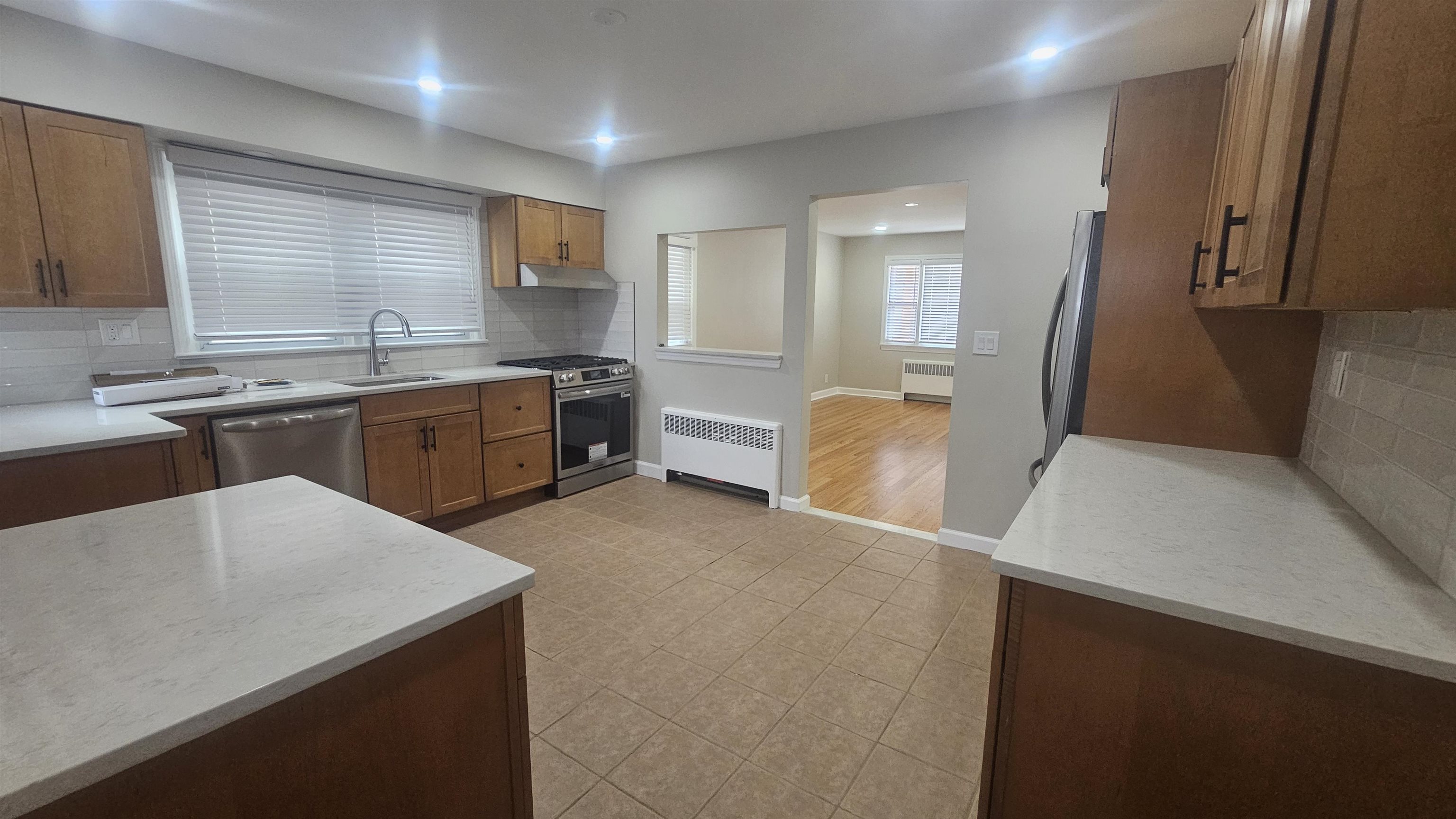 736 3rd Street, Unit 1 Secaucus, NJ 07094 - Photo 10 of 15 a large kitchen with cabinets and wooden floor