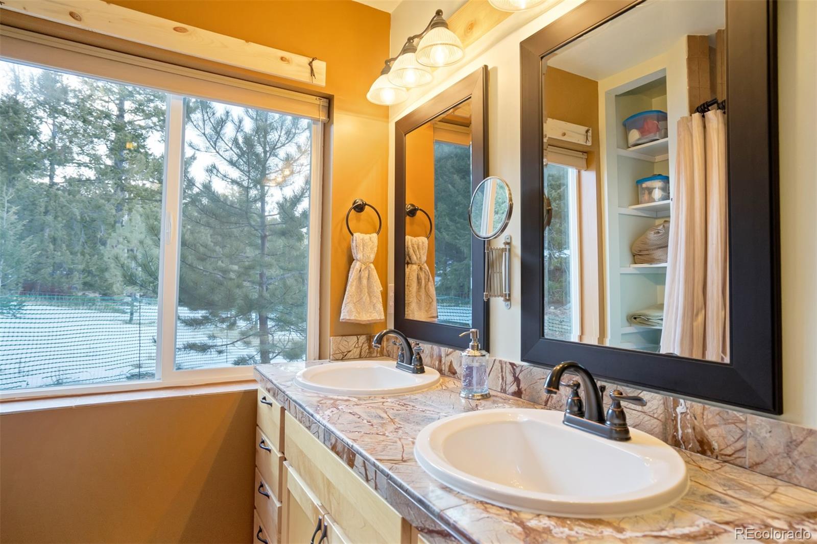 10424 Ranch Road Hartsel, CO 80449 - Photo 11 of 31 a bathroom with a granite countertop sink and a mirror