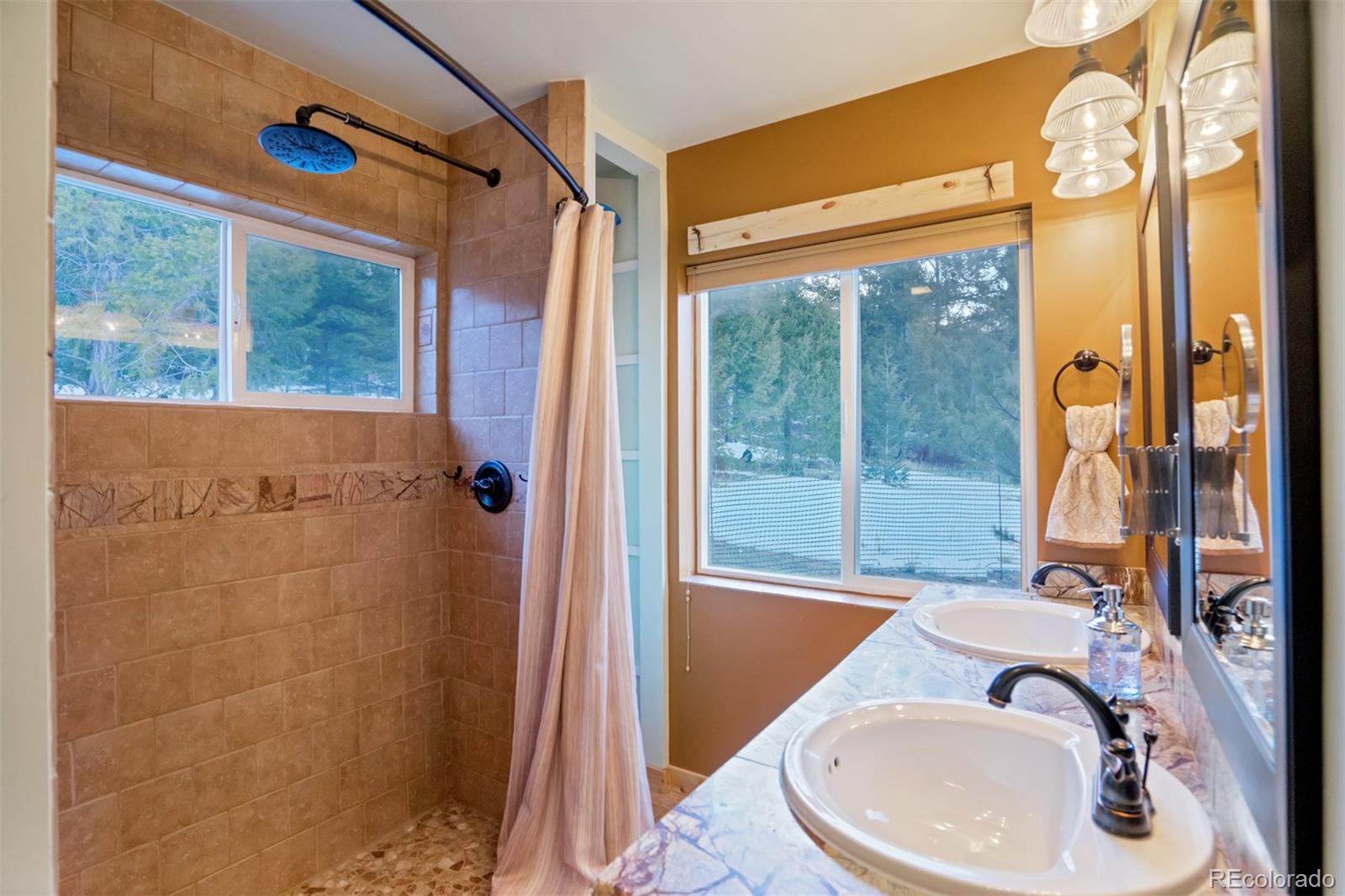 10424 Ranch Road Hartsel, CO 80449 - Photo 12 of 31 a bathroom with a sink and a large mirror