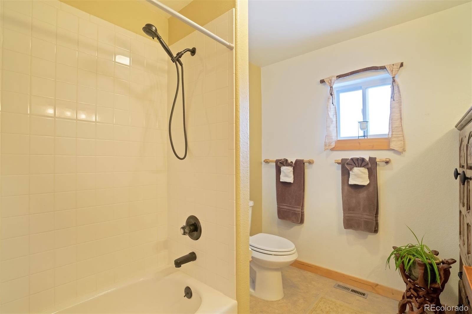 10424 Ranch Road Hartsel, CO 80449 - Photo 16 of 31 a bathroom with a shower a toilet and sink