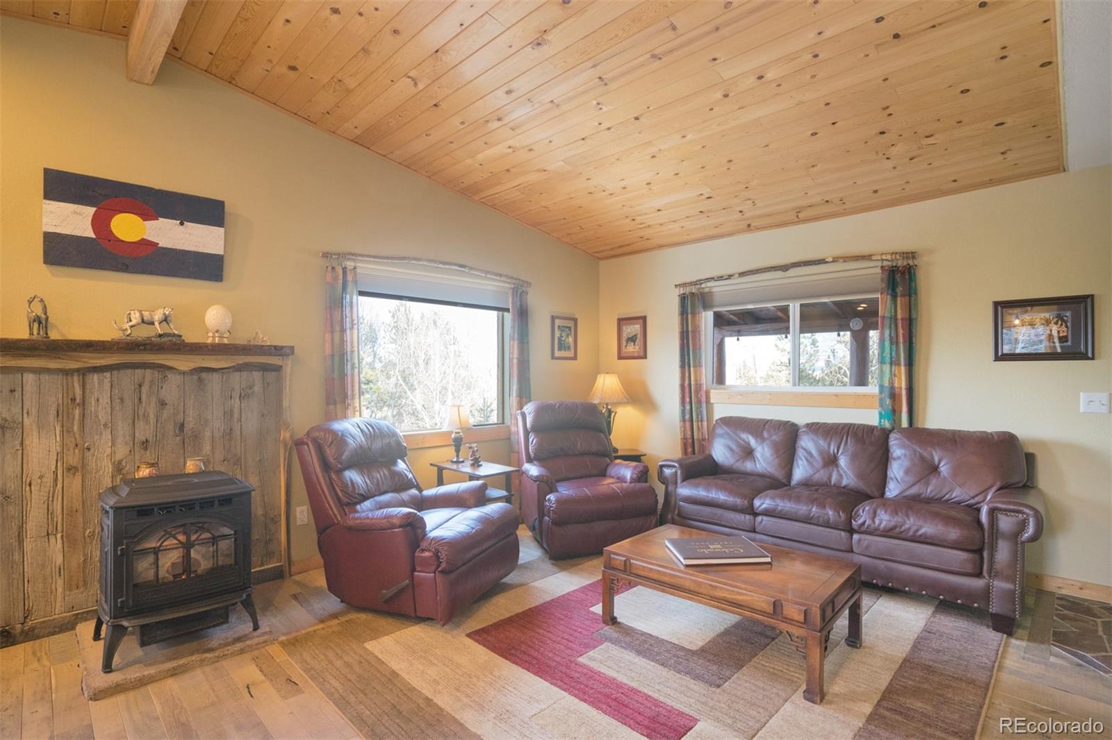 10424 Ranch Road Hartsel, CO 80449 - Photo 8 of 31 a living room with furniture a fireplace and a window