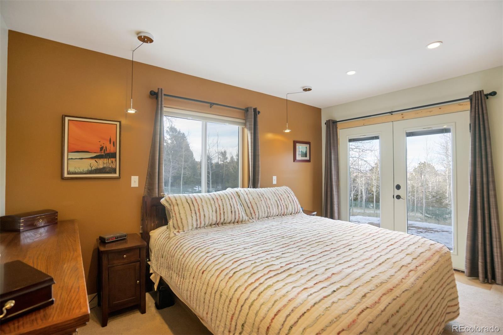 10424 Ranch Road Hartsel, CO 80449 - Photo 10 of 31 a bedroom with a bed and a large window