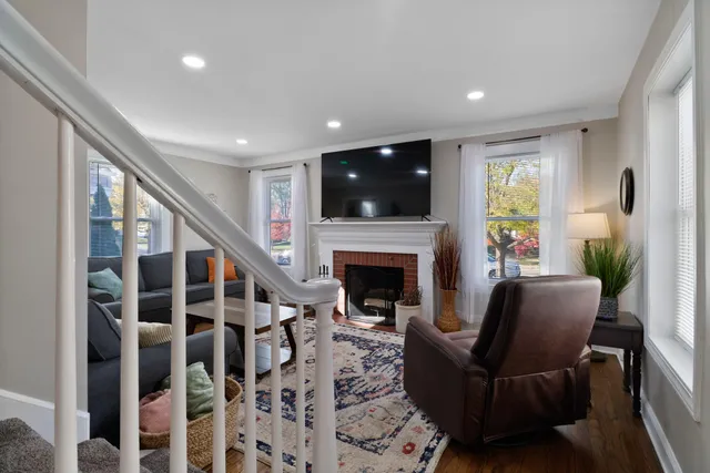 a living room with furniture a flat screen tv and a fireplace