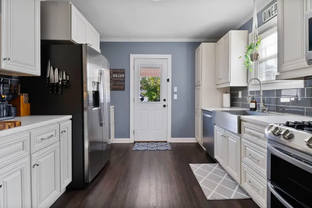 a kitchen with stainless steel appliances a stove a microwave and cabinets