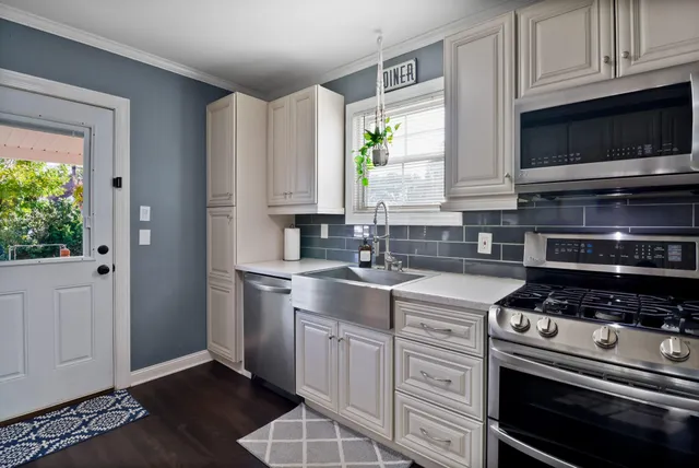 a kitchen with cabinets and stainless steel appliances