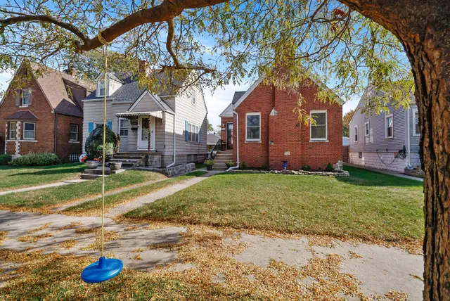 a house that has a tree in front of it