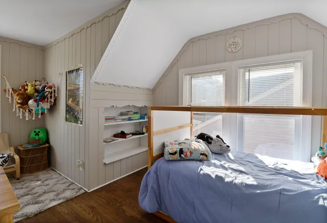a view of a workspace with wooden floor and a bathroom