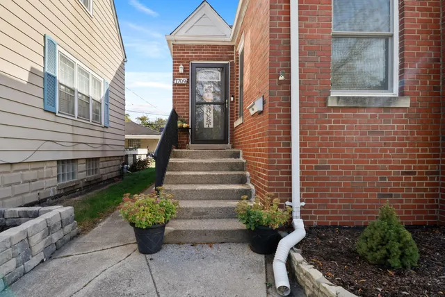 a view of a house with potted plants