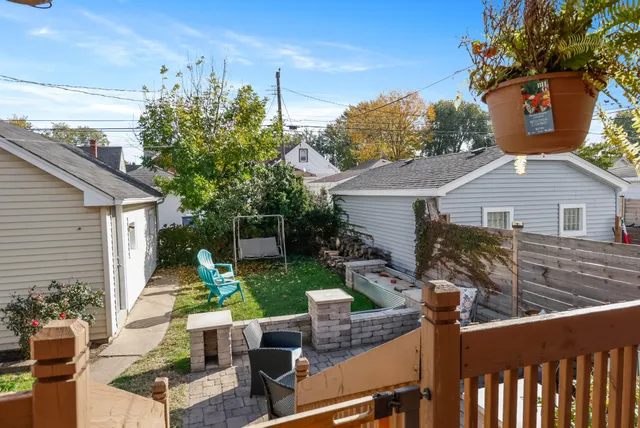 a view of backyard of house with seating space