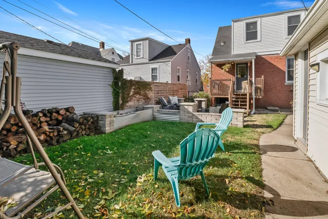 a view of an house with backyard and sitting area