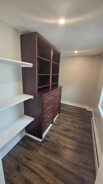 15 Central Street, Unit 4 Georgetown, MA 01833 - Photo 6 of 24 a view of an empty room with wooden floor and cabinet