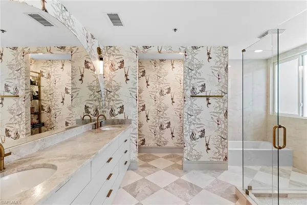 a bathroom with a granite countertop sink a shower and a mirror