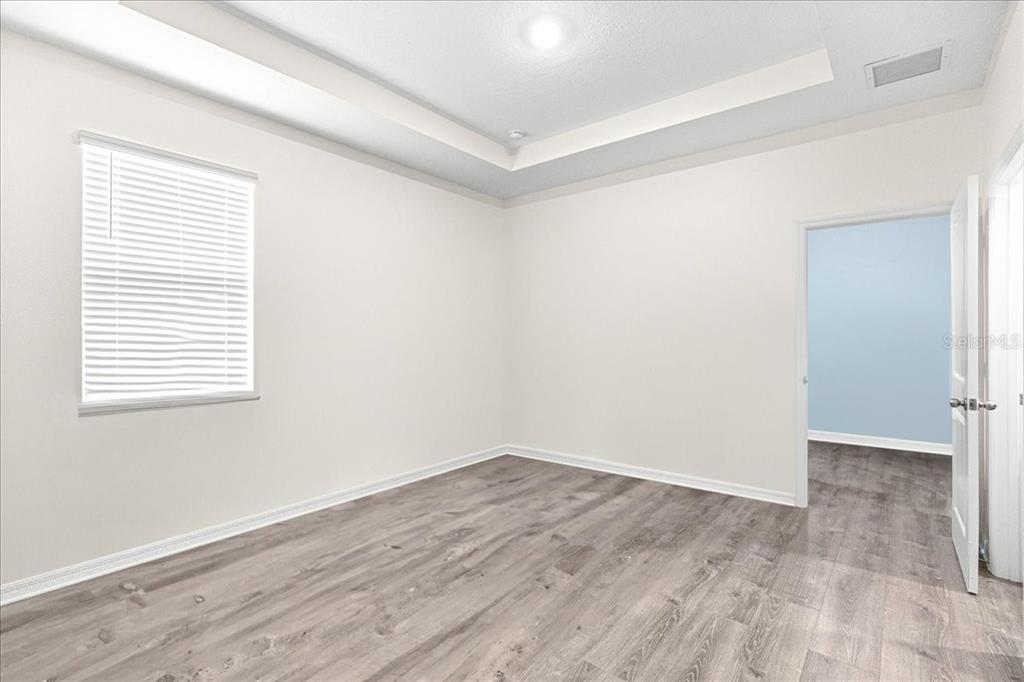 5851 Southwest 85th Place Ocala, FL 34476 - Photo 39 of 57 an empty room with wooden floor and windows