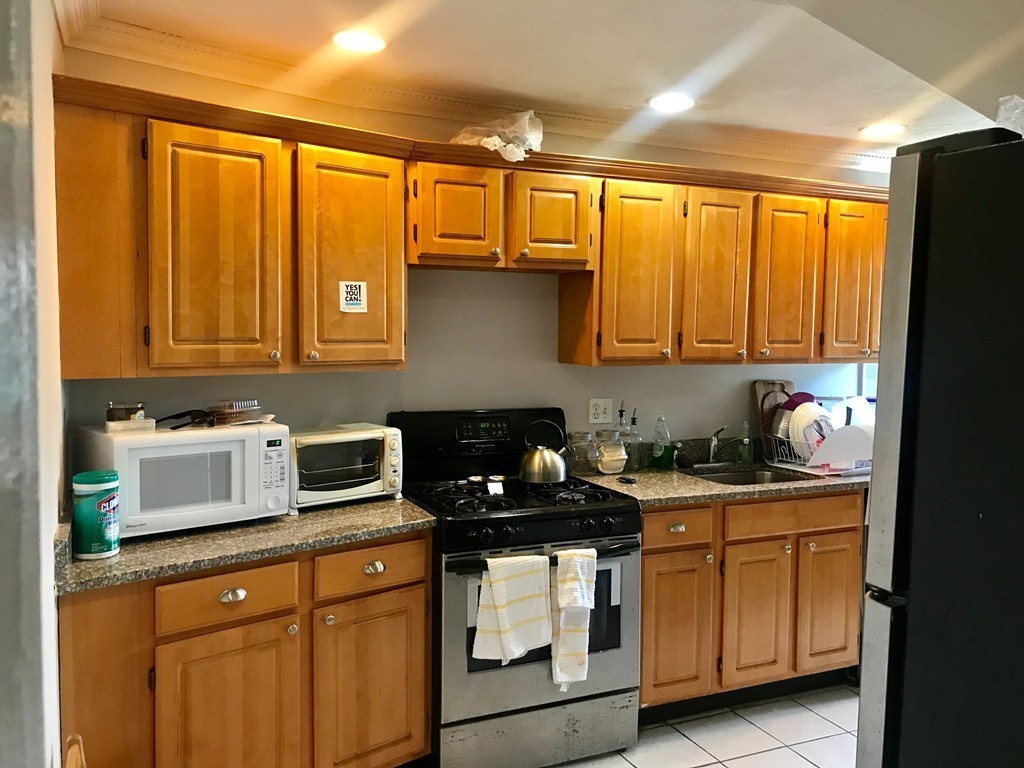 193 Hamilton Street, Unit 3 Boston, MA 02122 - Photo 1 of 8 a kitchen with stainless steel appliances granite countertop a stove a sink and cabinets