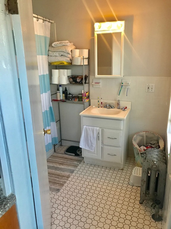 193 Hamilton Street, Unit 3 Boston, MA 02122 - Photo 6 of 8 a bathroom with a sink a toilet and shower