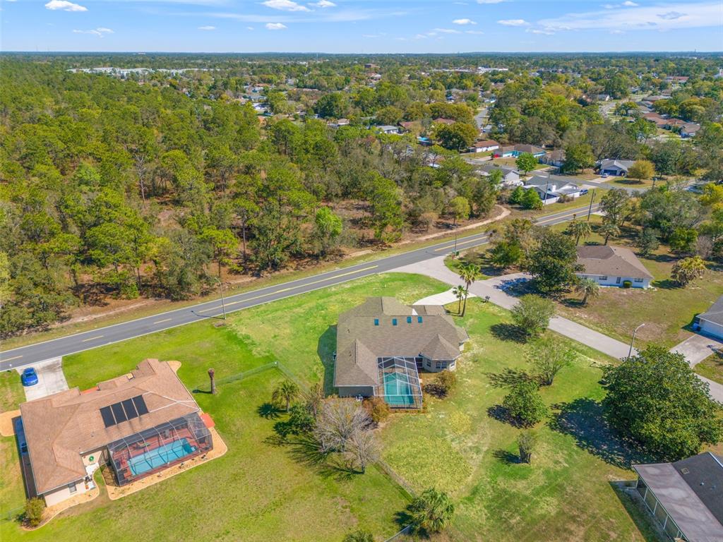 10185 Sleepy Willow Court Spring Hill, FL 34608 - Photo 1 of 44 an aerial view of residential houses with outdoor space