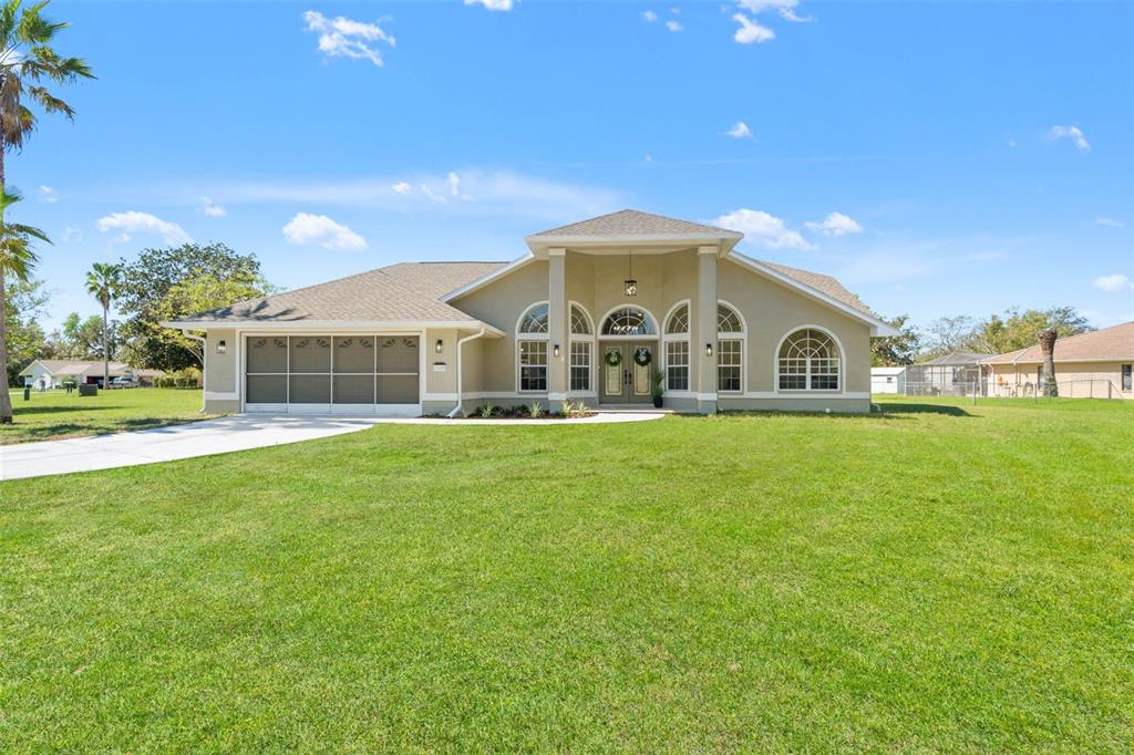 10185 Sleepy Willow Court Spring Hill, FL 34608 - Photo 2 of 44 a view of house with garden