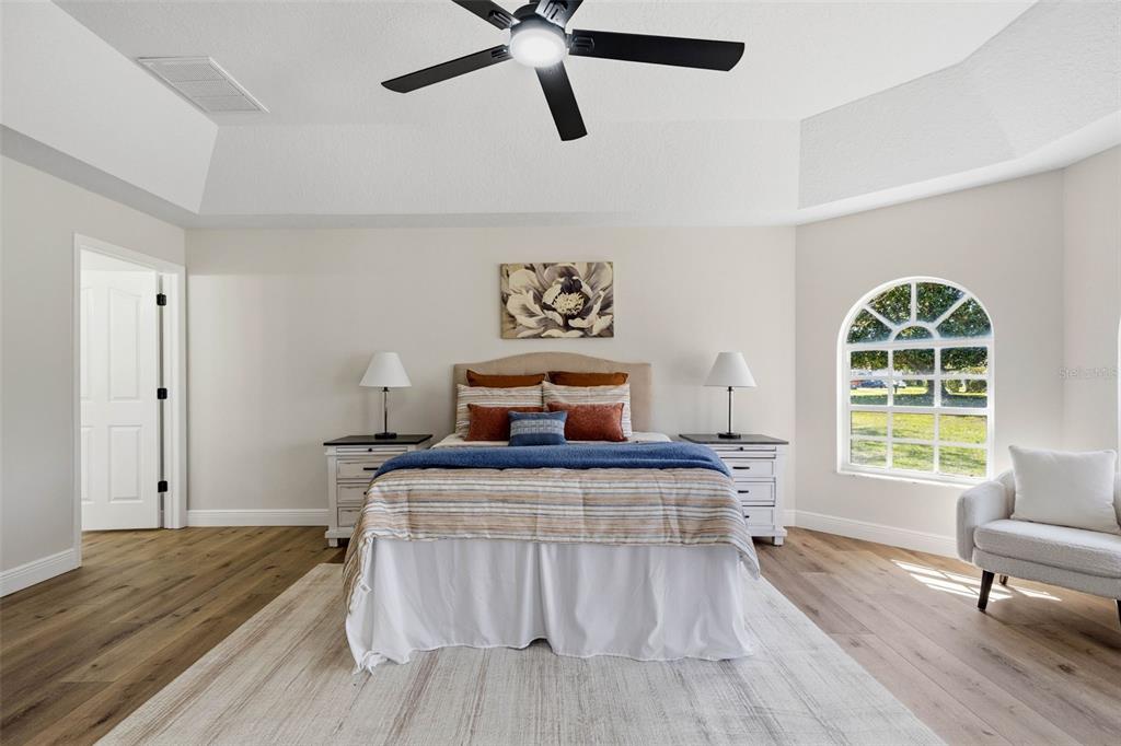 10185 Sleepy Willow Court Spring Hill, FL 34608 - Photo 22 of 44 a bedroom with a bed and a couch