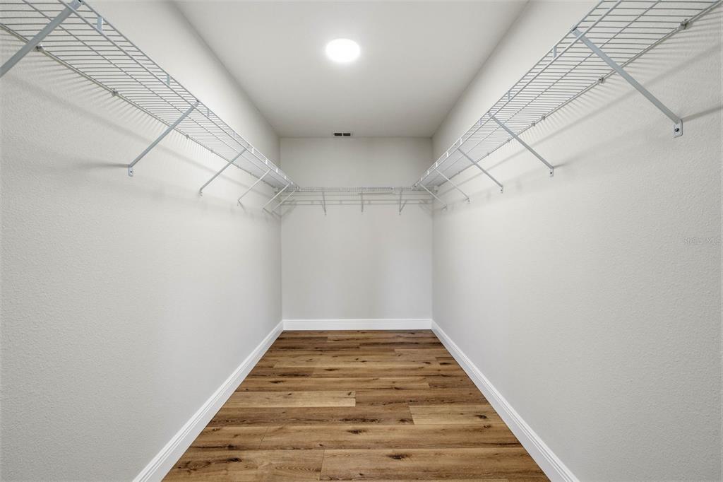 10185 Sleepy Willow Court Spring Hill, FL 34608 - Photo 27 of 44 a view of a hallway with wooden floor