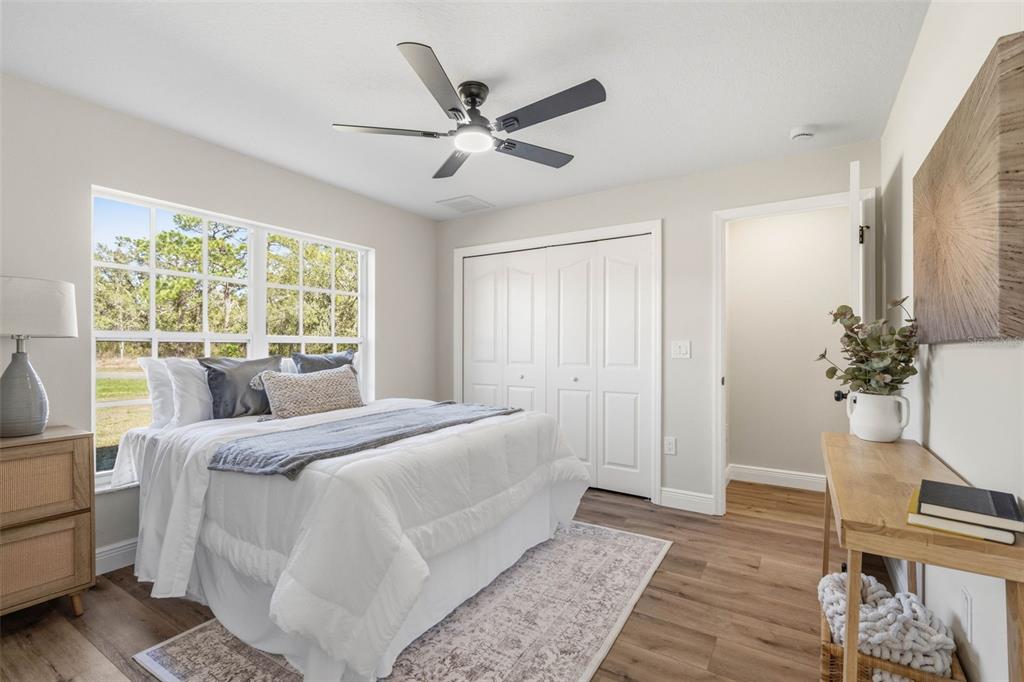 10185 Sleepy Willow Court Spring Hill, FL 34608 - Photo 28 of 44 a bed room with a bed and a window
