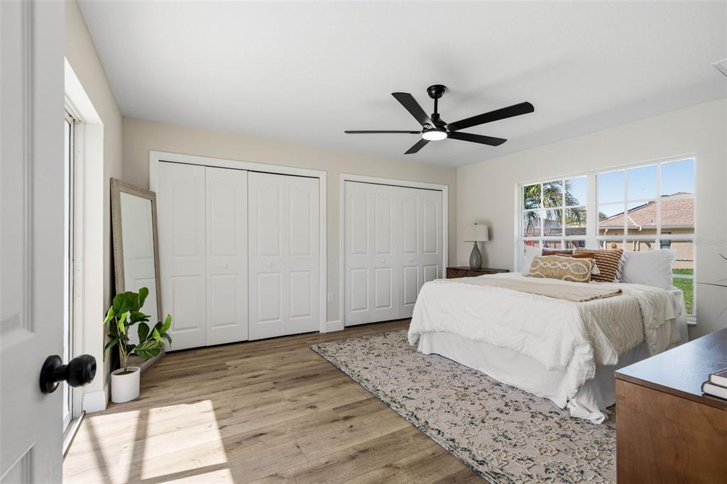 10185 Sleepy Willow Court Spring Hill, FL 34608 - Photo 34 of 44 a bedroom with a bed and a potted plant