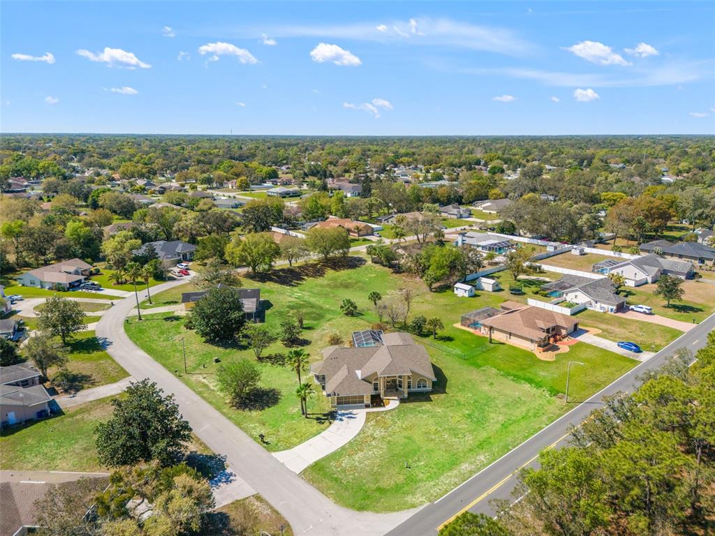 10185 Sleepy Willow Court Spring Hill, FL 34608 - Photo 44 of 44 an aerial view of residential houses with outdoor space