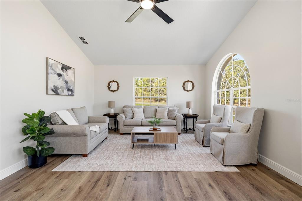 10185 Sleepy Willow Court Spring Hill, FL 34608 - Photo 7 of 44 a living room with furniture and a large window